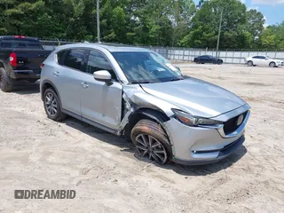 2018 Mazda CX-5 Grand Touring with VIN JM3KFADM4J0308971, listed as a IAAI auction lot 42562333 with 104,237 mi miles and . Bid and sale history available at DreamBid. Image 1.