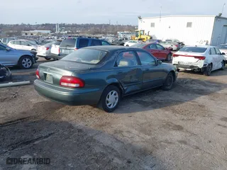 1999 Mazda 626 ES with VIN 1YVGF22C0X5835930, listed as a IAAI auction lot 41666820 with 93,973 mi miles. Bid and sale history available at carsss.com. Image 4.