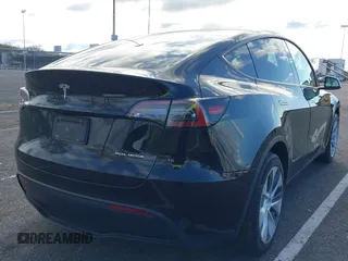 2022 Tesla Model Y Long Range with VIN 7SAYGAEE4NF522330, listed as a IAAI auction lot 42046691 with 59,980 mi miles and . Bid and sale history available at carsss.com. Image 4.