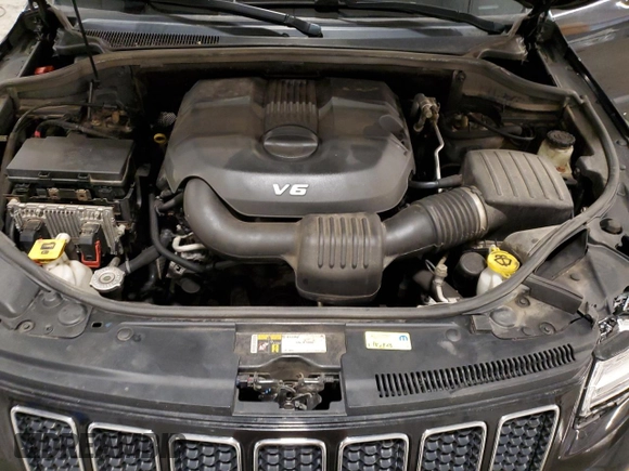 2015 Jeep Grand Cherokee Overland with VIN 1C4RJFCG7FC911899, listed as a Copart auction lot 54123925 with 243,031 mi miles and Salvage Title. Bid and sale history available at carsss.com. Image 12.