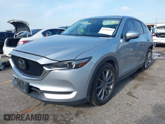 2020 Mazda CX-5 Grand Touring with VIN JM3KFADM5L0739306, listed as a IAAI auction lot 42215667 with 126,100 mi miles and . Bid and sale history available at DreamBid. Image 2.