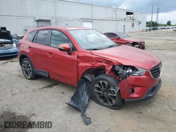 2016 Mazda CX-5 Grand Touring with VIN JM3KE4DY0G0664379, listed as a Copart auction lot 54659005 with 116,022 mi miles and Salvage Title. Bid and sale history available at DreamBid. Image 4.