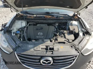 2016 Mazda CX-5 Grand Touring z VIN JM3KE4DY7G0864109, wystawiony jako Copart lot #59635865 z przebiegiem Nie podano mil oraz Czysty tytuł • Clean title. Historia ofert i sprzedaży dostępna na DreamBid. Obrazek 11.