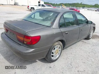2000 Saturn SL z VIN 1G8ZK527XYZ121984, wystawiony jako IAAI lot #42099839 z przebiegiem 174 210 mil mil oraz . Historia ofert i sprzedaży dostępna na DreamBid. Obrazek 4.