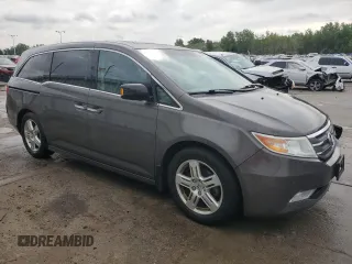 2012 Honda Odyssey Touring with VIN 5FNRL5H94CB109257, listed as a Copart auction lot 59636075 with 107,543 mi miles and Salvage title. Bid and sale history available at DreamBid. Image 4.
