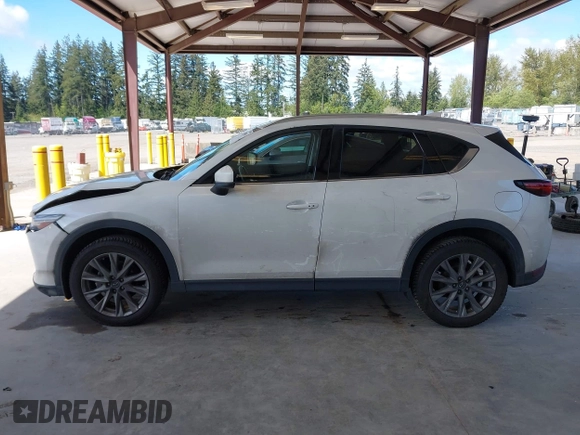 2020 Mazda CX-5 Grand Touring with VIN JM3KFBDM2L0863944, listed as a IAAI auction lot 42150805 with 63,932 mi miles and . Bid and sale history available at DreamBid. Image 14.
