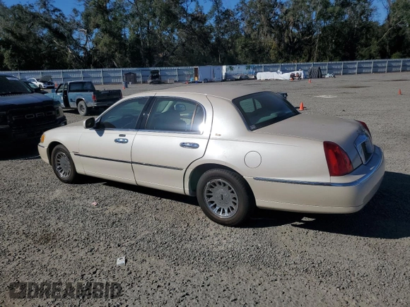 2001 Lincoln Town Car Cartier z VIN 1LNHM83W31Y671814, wystawiony jako Copart lot #77169664 z przebiegiem Nie podano mil oraz Szkoda całkowita • Salvage title. Historia ofert i sprzedaży dostępna na DreamBid. Obrazek 2.