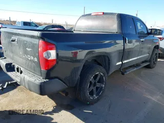 2014 Toyota Tundra 4WD Truck SR with VIN 5TFUM5F17EX051674, listed as a IAAI auction lot 41296906 with 140,782 mi miles. Bid and sale history available at carsss.com. Image 4.
