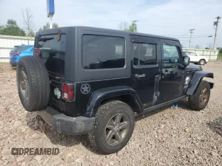2015 Jeep Wrangler Unlimited Freedom with VIN 1C4BJWDG4FL568601, listed as a Copart auction lot 64041415 with 128,874 mi miles and Salvage title. Bid and sale history available at DreamBid. Image 3.