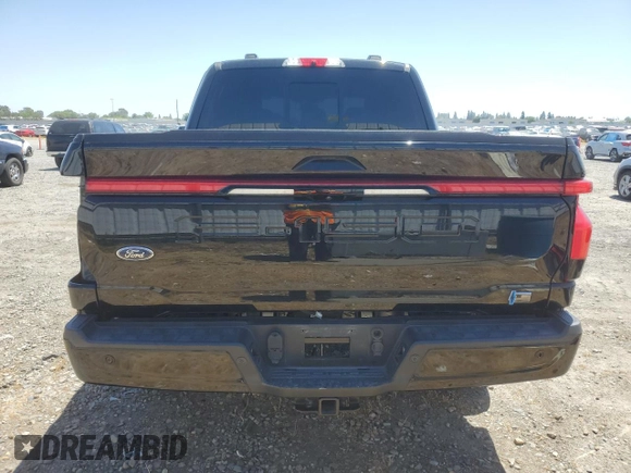 2023 Ford F-150 Lightning Pro with VIN 1FTVW1EV1PWG17333, listed as a Copart auction lot 57904025 with 21,173 mi miles and Salvage title. Bid and sale history available at DreamBid. Image 6.