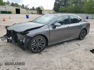 2025 Toyota Camry LE with VIN 4T1DAACKXSU556874, listed as a Copart auction lot 52694525 with 7,076 mi miles and Salvage Title. Bid and sale history available at carsss.com. Image 1.
