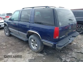 1997 GMC Yukon with VIN 1GKEK13R6VJ715421, listed as a IAAI auction lot 41811398 with 214,735 mi miles. Bid and sale history available at carsss.com. Image 3.