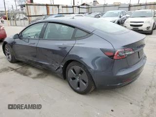 2023 Tesla Model 3 with VIN 5YJ3E1EA3PF697049, listed as a Copart auction lot 55601295 with 12,373 mi miles and Salvage Title. Bid and sale history available at DreamBid. Image 2.