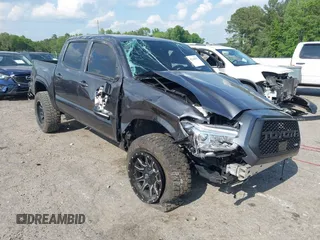 2022 Toyota Tacoma SR with VIN 3TYCZ5AN2NT096247, listed as a IAAI auction lot 42160833 with 43,556 mi miles and . Bid and sale history available at DreamBid. Image 1.