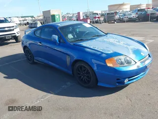2004 Hyundai Tiburon GT z VIN KMHHN65F14U113633, wystawiony jako IAAI lot #41393067 z przebiegiem 157 195 mil mil oraz . Historia ofert i sprzedaży dostępna na DreamBid. Obrazek 1.