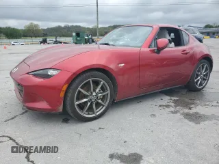 2021 Mazda MX-5 Miata Grand Touring z VIN JM1NDAM78M0451030, wystawiony jako Copart lot #52005875 z przebiegiem Nie podano mil oraz Szkoda całkowita • Salvage title. Historia ofert i sprzedaży dostępna na DreamBid. Obrazek 1.