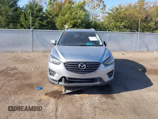 2016 Mazda CX-5 Grand Touring z VIN JM3KE2DY3G0712249, wystawiony jako IAAI lot #37910910 z przebiegiem 262 058 mil mil oraz . Historia ofert i sprzedaży dostępna na DreamBid. Obrazek 12.