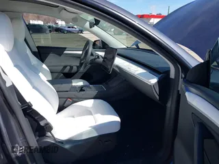 2023 Tesla Model Y Long Range with VIN 7SAYGDEE2PF883687, listed as a IAAI auction lot 41589837 with 36,890 mi miles. Bid and sale history available at carsss.com. Image 5.