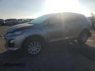 2012 Mazda CX-7 i Sport z VIN JM3ER2B55C0414175, wystawiony jako Copart lot #49305805 z przebiegiem 127 526 mil mil oraz Szkody całkowita. Historia ofert i sprzedaży dostępna na DreamBid. Obrazek 1.
