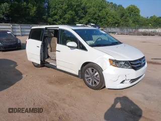 2014 Honda Odyssey Touring with VIN 5FNRL5H92EB059770, listed as a IAAI auction lot 42591245 with 145,567 mi miles and . Bid and sale history available at DreamBid. Image 1.