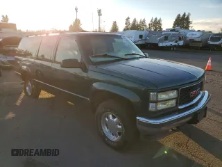 1997 GMC Suburban with VIN 3GKFK16RXVG513571, listed as a Copart auction lot 82086924 with 190,142 mi miles and Salvage title. Bid and sale history available at DreamBid. Image 4.