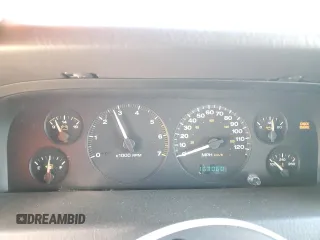 1999 Jeep Grand Cherokee Laredo with VIN 1J4GW58NXXC776438, listed as a Copart auction lot 84412044 with 163,060 mi miles and Salvage title. Bid and sale history available at DreamBid. Image 9.