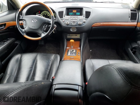 2002 Infiniti Q45 z VIN JNKBF01A52M002920, wystawiony jako Copart lot #73249364 z przebiegiem 95 955 mil mil oraz Tytuł czysty. Historia ofert i sprzedaży dostępna na DreamBid. Obrazek 8.