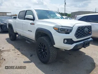 2021 Toyota Tacoma SR5 z VIN 5TFDZ5BN9MX057873, wystawiony jako IAAI lot #42172273 z przebiegiem 69 543 mil mil oraz . Historia ofert i sprzedaży dostępna na DreamBid. Obrazek 1.