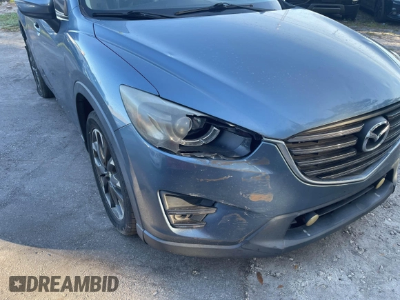 2016 Mazda CX-5 Grand Touring with VIN JM3KE4DY9G0673789, listed as a IAAI auction lot 42196841 with 98,622 mi miles and . Bid and sale history available at DreamBid. Image 6.