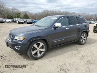 2015 Jeep Grand Cherokee Overland with VIN 1C4RJFCG1FC115844, listed as a Copart auction lot 47490555 with 215,263 mi miles and Salvage title. Bid and sale history available at DreamBid. Image 1.