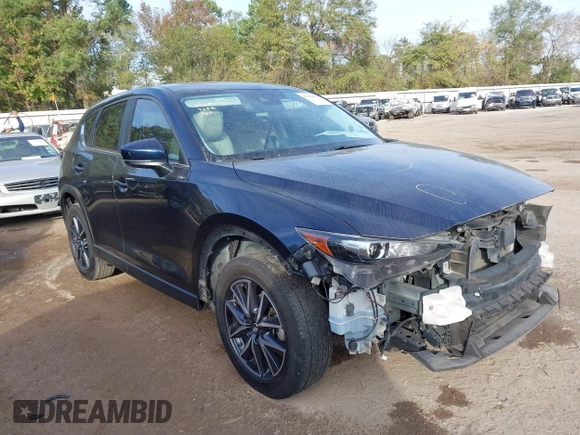 2018 Mazda CX-5 Touring z VIN JM3KFACM0J1389057, wystawiony jako IAAI lot #40922679 z przebiegiem 140 026 mil mil oraz . Historia ofert i sprzedaży dostępna na DreamBid. Obrazek 1.