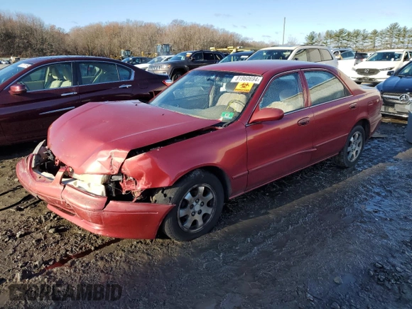 2000 Mazda 626 LX z VIN 1YVGF22CXY5172092, wystawiony jako Copart lot #81960694 z przebiegiem 214 185 mil mil oraz Szkoda całkowita • Salvage title. Historia ofert i sprzedaży dostępna na DreamBid. Obrazek 1.