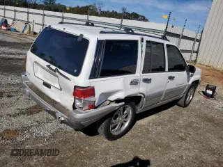 1996 Jeep Grand Cherokee Laredo with VIN 1J4FX58SXTC349575, listed as a Copart auction lot 80545584 with 302,636 mi miles and Salvage Title. Bid and sale history available at carsss.com. Image 3.