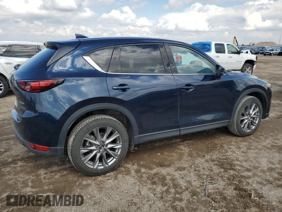 2021 Mazda CX-5 Grand Touring with VIN JM3KFBDM0M0500561, listed as a Copart auction lot 58214665 with 49,543 mi miles and Salvage title. Bid and sale history available at DreamBid. Image 3.