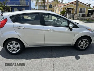 2015 Ford Fiesta SE z VIN 3FADP4EJ8FM167515, wystawiony jako IAAI lot #42153873 z przebiegiem 100 559 mil mil oraz . Historia ofert i sprzedaży dostępna na DreamBid. Obrazek 14.