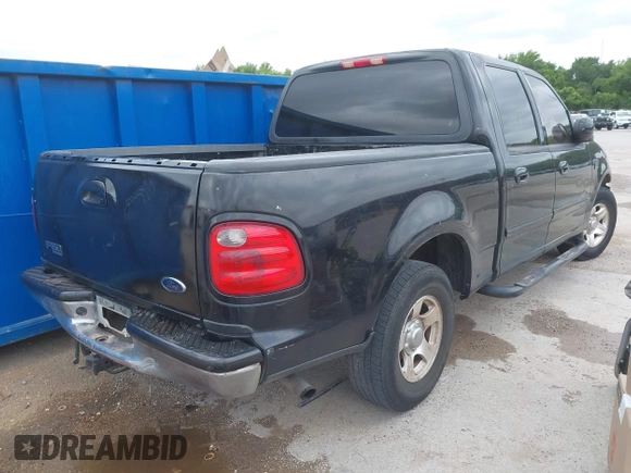 2002 Ford F-150 XLT with VIN 1FTRW07692KE26387, listed as a IAAI auction lot 42079023 with 218,876 mi miles. Bid and sale history available at carsss.com. Image 4.