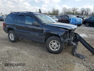 2004 Jeep Grand Cherokee Laredo with VIN 1J4GW48S84C184757, listed as a Copart auction lot 52895745 with 242,307 mi miles and Salvage Title. Bid and sale history available at carsss.com. Image 4.