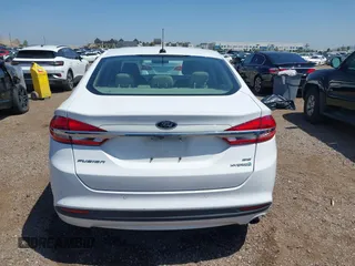 2018 Ford Fusion SE z VIN 3FA6P0LU2JR261268, wystawiony jako IAAI lot #42301578 z przebiegiem 63 357 mil mil oraz . Historia ofert i sprzedaży dostępna na DreamBid. Obrazek 16.
