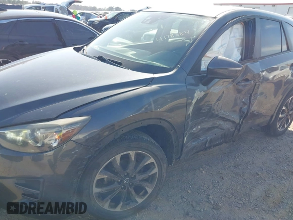 2016 Mazda CX-5 Grand Touring with VIN JM3KE4DY8G0823567, listed as a IAAI auction lot 41784384 with 143,836 mi miles and . Bid and sale history available at carsss.com. Image 6.