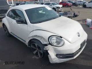 2012 Volkswagen Beetle 2.0T Turbo w/Sun/Snd/Nav PZEV with VIN 3VWVA7ATXCM620731, listed as a IAAI auction lot 41074530 with 99,236 mi miles. Bid and sale history available at carsss.com. Image 1.