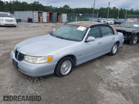 1998 Lincoln Town Car Signature with VIN 1LNFM82WXWY659028, listed as a IAAI auction lot 42265774 with 164,400 mi miles and . Bid and sale history available at DreamBid. Image 2.