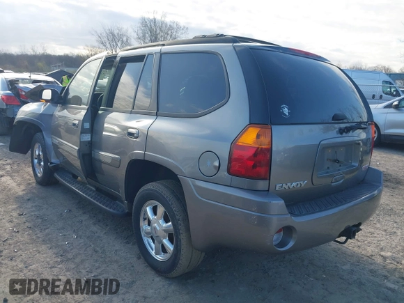 2005 GMC Envoy SLE with VIN 1GKDT13S852362380, listed as a IAAI auction lot 42031727 with 76,711 mi miles. Bid and sale history available at carsss.com. Image 3.