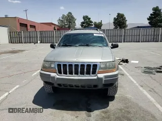 1999 Jeep Grand Cherokee Laredo with VIN 1J4GW58S1XC775877, listed as a Copart auction lot 55639795 with 197,611 mi miles and Salvage title. Bid and sale history available at DreamBid. Image 14.