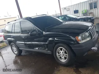 2004 Jeep Grand Cherokee Laredo with VIN 1J4GX48N94C435700, listed as a IAAI auction lot 41809624 with 147,413 mi miles. Bid and sale history available at carsss.com. Image 13.