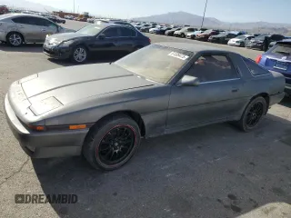 1987 Toyota Supra z VIN JT2MA71J0H0029369, wystawiony jako Copart lot #51339475 z przebiegiem 124 940 mil mil oraz Czysty tytuł • Clean title. Historia ofert i sprzedaży dostępna na DreamBid. Obrazek 1.