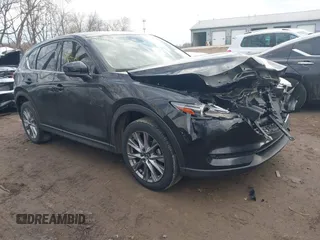 2021 Mazda CX-5 Grand Touring with VIN JM3KFBDM6M0451799, listed as a IAAI auction lot 41672121 with 55,756 mi miles. Bid and sale history available at carsss.com. Image 1.