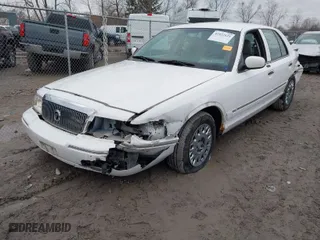 2004 Mercury Grand Marquis GS with VIN 2MEFM74W24X628573, listed as a IAAI auction lot 41922123 with 104,395 mi miles. Bid and sale history available at carsss.com. Image 2.