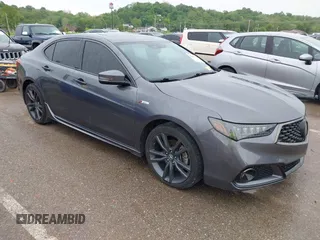 2019 Acura TLX w/A-Spec Pkg z VIN 19UUB2F61KA000932, wystawiony jako IAAI lot #42164064 z przebiegiem 79 080 mil mil oraz . Historia ofert i sprzedaży dostępna na DreamBid. Obrazek 1.