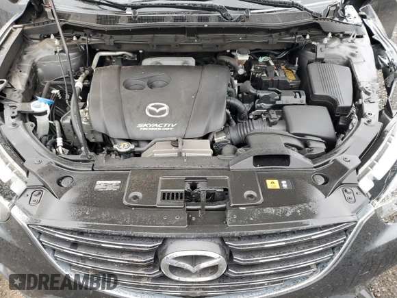 2016 Mazda CX-5 Grand Touring z VIN JM3KE2DY9G0687261, wystawiony jako Copart lot #52865415 z przebiegiem Nie podano mil oraz Szkoda całkowita • Salvage title. Historia ofert i sprzedaży dostępna na DreamBid. Obrazek 13.