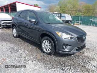 2014 Mazda CX-5 Touring z VIN JM3KE2CY2E0390069, wystawiony jako IAAI lot #42160764 z przebiegiem 126 445 mil mil oraz . Historia ofert i sprzedaży dostępna na DreamBid. Obrazek 1.